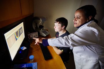 A clinician reviewing a record on screen